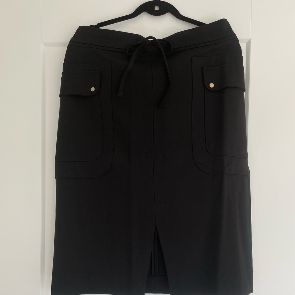 Tags on black stretch jersey pencil skirt. British brand Me&Em. Size 12 CDN.